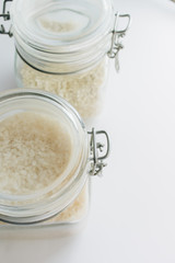 Obraz na płótnie Canvas Pile of raw white rice in jar , macro 