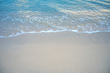 Sandy beach with soft blue wave