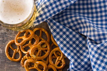 Oktoberfest beer with pretzels on wooden table. Top view