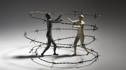 Fighters in a barbed wire arena. Competition concept. Isolated on dark background. Copy text space.