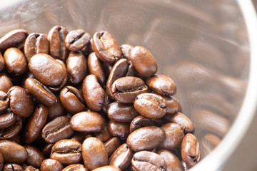 Coffee beans background.Brown roasted coffee beans pattern in coffee shop prepared for making cappuccino or latte hot drink.