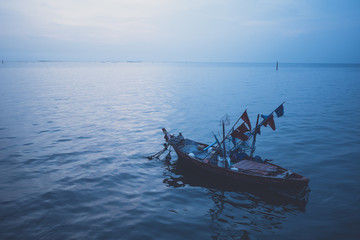 local fishing boat in the sea at sunset
