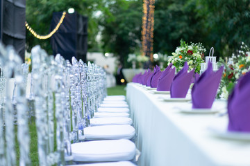 Luxury White - Purple - Red Dinner table set with Crystal chair in the garden.