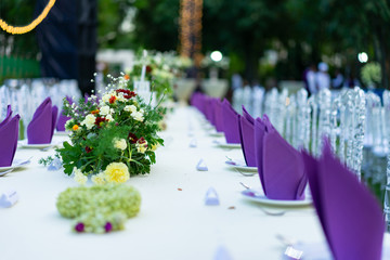 Luxury White - Purple - Red Dinner table set with Crystal chair in the garden.