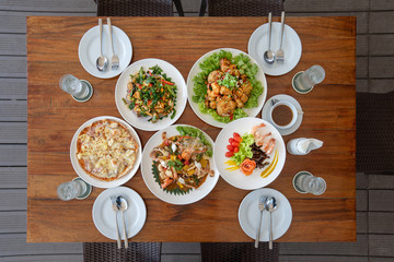 Thai applied Lunch set such as Seafood fried with sauce, pizza, salmon salad, and fried shrimp on...