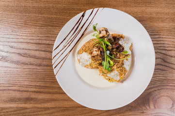  chicken legs in breading on a plate with sauce