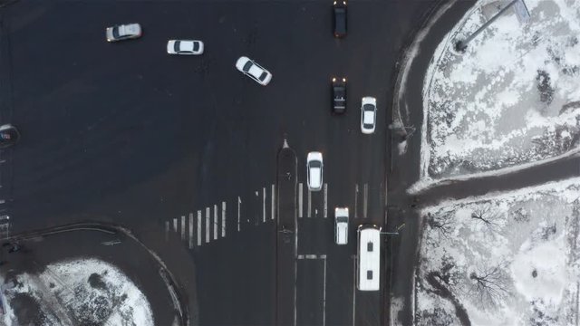vehicles from three lanes disperse in different directions at the intersection.