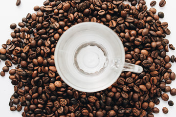 Close-up view of roasted coffee beans and glass cup 