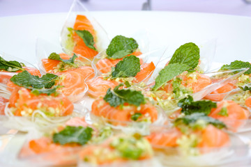 Salon spicy salad in Thai food style, in the plastic spoons on the dish that ready to serve in the event.