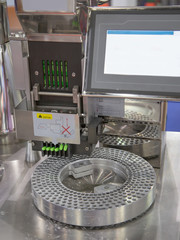 Capsule pharmaceutical pills counting and filling machine. Pharmaceutical industry