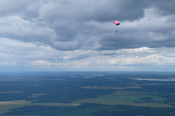 Skydiving. A parachute is in the sky.