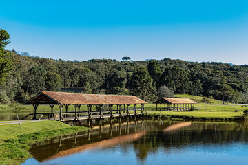 Fototapeta premium Two covered bridges in a park on a sunny morning