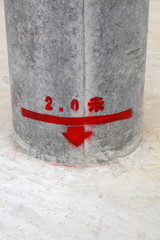 Red handwriting on the cement pole