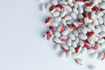 Raw beans in jar on white background
