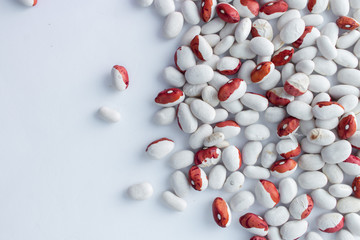 Raw beans in jar on white background