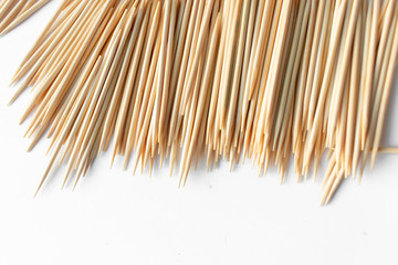 Pile of scattered toothpicks on white background