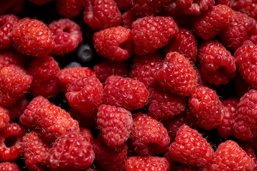 close up view of tasty ripe mixed raspberries and blueberries
