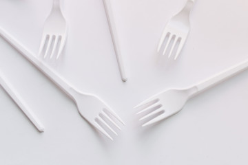 White plastic forks flat lay on white background