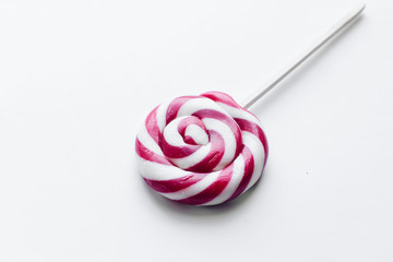 Sweet pink lollipop on white background