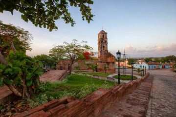 Beautiful View of a Church in a small touristic Cuban Town during a vibrant sunny and cloudy sunrise. Taken in Trinidad, Cuba.