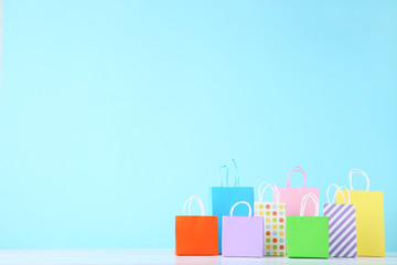 Small paper shopping bags on blue background