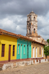 View of Residential Homes and a Church in a small touristic Cuban Town during a vibrant sunny and rainy day. Taken in Trinidad, Cuba.