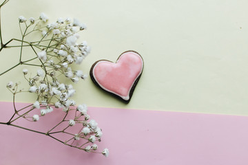 Cookie in heart shape with red glaze and white flowers , valentines day concept, love heart