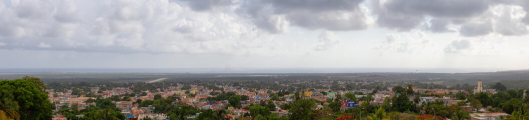 Aerial panoramic view of a small touristic Cuban Town during a colorful and cloudy sunset. Taken in Trinidad, Cuba.