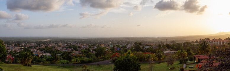 Aerial panoramic view of a small touristic Cuban Town during a colorful and cloudy sunset. Taken in Trinidad, Cuba.