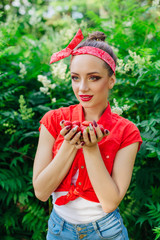 Beautiful young pin up girl with bright make up and fresh natural strawberry.