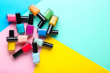 Nail polish bottles on colorful background