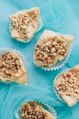 Baklava dessert. Pastry made of layers of filo filled with chopped nuts and sweetened and held...