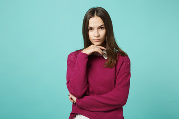 Young brunette woman girl in casual clothes posing isolated on blue green turquoise background studio portrait. People sincere emotions lifestyle concept. Mock up copy space. put hand prop up on chin