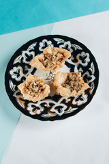 Baklava on plate. Pastry made of layers of filo filled with chopped nuts and sweetened and held together with syrup or honey