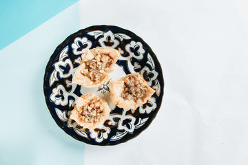 Baklava on plate. Pastry made of layers of filo filled with chopped nuts and sweetened and held...