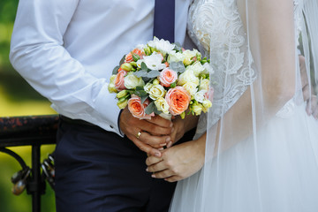 a bouquet of flowers in the hands of the bride