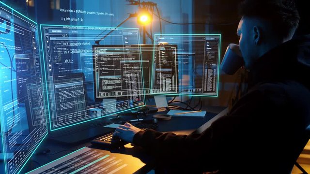 cybercrime, hacking and technology concept - asian male hacker in dark room writing code or using computer virus program for cyber attack