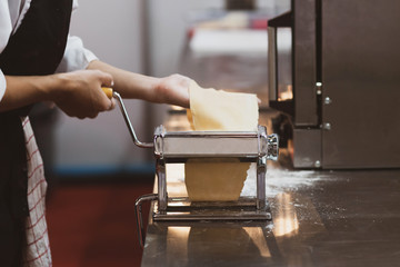 Chef making pasta with a machine, home made fresh pasta