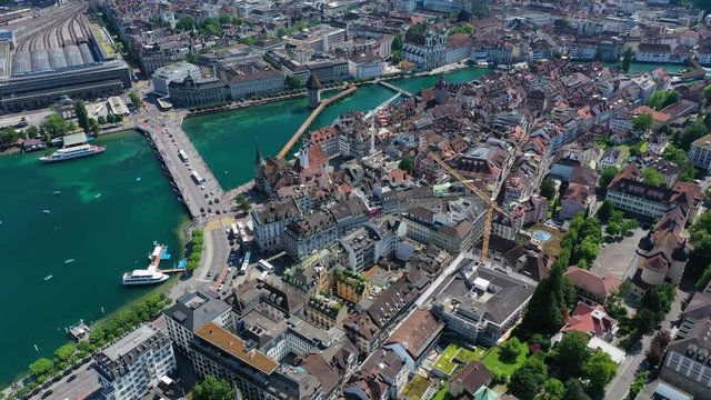 Aerial view of cityscape of Lucerne, historic centre of city, famous landmark Chapel Bridge (Kapellbrücke) across river Reuss - landscape panorama of Switzerland from above, Europe