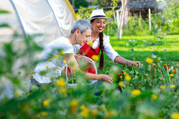 Two women working in her vegetable garden