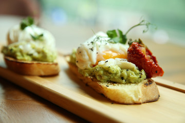 Sandwich with poached egg. Beautifully decorated breakfast. Close-up.