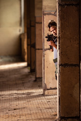 Young woman playing airsoft game indoors