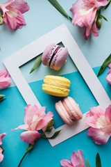 Composition of delicious macaroons on festive background 