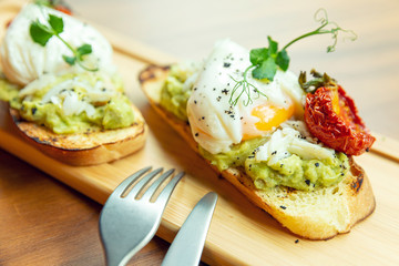 Sandwich with poached egg. Beautifully decorated breakfast. Close-up.