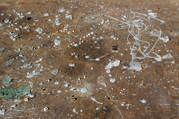 abstract drops of grey color paint on rust brown metal iron surface 