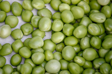 Background with fresh organic green peas. Close-up view from above.