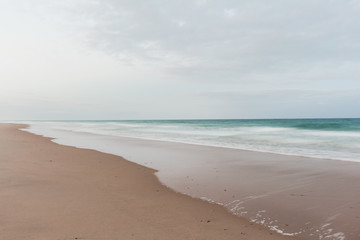 Morning on the beach with smooth waves