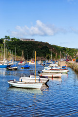 Colourful boats in old Fishguard harbour, Wales UK