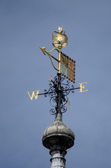 A golden vane on the roof of a building in London