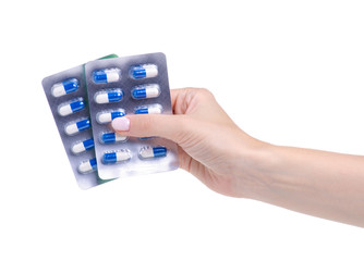 Pills capsules in blister in hand medicine health on white background isolation